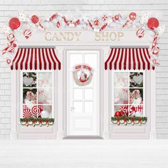 a candy shop with red and white striped awnings on the front door, decorated for christmas