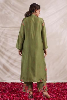 Green silk kurta with front gathered panel, multi color placement floral print, sequin, bead and French knot thread embroidered highlights. Paired with palazzo with printed border.
Components: 2
Pattern: Printed and Hand Embroidered
Type Of Work: Floral Print, Bead, Sequin and French Knot Thread Work
Neckline: V Neck
Sleeve Type: Full Sleeves
Fabric: Silk
Color: Green
Other Details: 
Embroidered yoke
Side slits
Embroidered highlights
Model height: 5ft inches, wearing size S
Note: Kindly contact Knot Thread, Kurta And Palazzo, Kurta Palazzo Set, Palazzo Set, Silk Kurta, French Knot, Fabric Silk, Thread Work, Green Silk