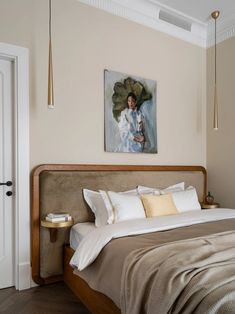 a bedroom with a bed and paintings on the wall