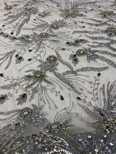 This beautiful luxury lace is classy and sophisticated. This fabric is available and sold at 1/2 or 1 plus a yard This rich lace is perfect for bridal wear, evening gowns, dresses, and more. Also use this fabric as an applique to design your next dress to brighten and sparkle up your next special occasion, wedding, and etc. 58'' - 59'' wide Elegant Embroidered Fabric With Lace Work For Banquet, Elegant Embroidered Fabric With Lace Work For Banquets, Elegant Tulle Fabric With 3d Lace Embroidery, Elegant Lace Tulle Fabric With 3d Embroidery, Elegant Embroidered Tulle Fabric, Elegant Silver Embroidered Fabric With Lace Work, Elegant Embroidered Fabric With Appliques For Party, Elegant Lace Fabric With Appliques, Elegant Lace Embroidered Fabric With Appliques