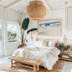 a bedroom with white walls and flooring has a bed made up in wicker