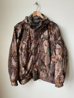 Up for sale is this Rivers West Pioneer Waterproof Fleece Camo Hunting Jacket Size Medium.  This jacket is in excellent used condition with only very minor signs of use as you can see in the photos.   The item will ship one business day after the payment is received. Here are the measurements while laying flat: Chest from armpit to armpit:  25 inches Length from shoulder to the bottom:  28 inches Arm from armpit to end at wrist:  22 inches Winter Camouflage Nylon Outerwear, Camouflage Windproof Outerwear For Hiking, Camouflage Windproof Outerwear For Outdoor, Camouflage Winter Outerwear For Outdoor Work, Camouflage Long Sleeve Windbreaker For Outdoor, Winter Camouflage Outerwear For Hiking, Winter Camouflage Hiking Outerwear, Winter Hunting Camouflage Outerwear, Winter Camouflage Hunting Outerwear