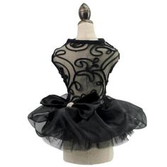 a mannequin wearing a black and white tutu with a large bow on it's head