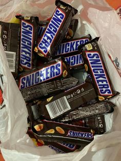 a bag full of snickkers chocolate bars sitting on top of each other in wrapper