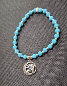 This is an EvilEye sterling silver charm. I used 6mm Opaque Turquoise faceted Blue Beads. I also used "24" 3mm Sterling Silver spacer beads, couple of 4mm sterling silver spacer beads, a 6mm Sterling Silver Stardust roundel spacer bead used as a closure. The  Evil Eye Charm is the Eye of Horus a Blue Eyed Egyptian. The Eye is supposed to give you health & protection. Sterling Silver Bracelets With Turquoise And Silver Beads, Turquoise Sterling Silver Bracelets With Silver Beads, Spiritual Nickel-free Turquoise Beaded Bracelets, Turquoise Beaded Bracelets With Silver Beads For Gift, Turquoise Spiritual Hypoallergenic Jewelry, Sterling Silver Beaded Bracelets With Silver Beads, Turquoise Sterling Silver Beaded Bracelets, Blue Round Spiritual Charm Bracelet, Spiritual Turquoise Charm Bracelet As Gift