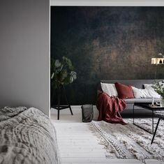 a living room with black marble walls and white carpeted flooring on the other side