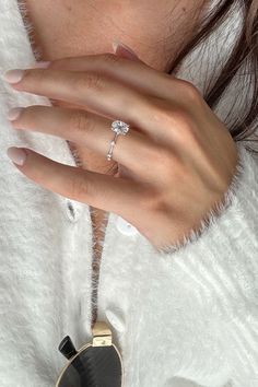 a close up of a person's hand with a ring on it