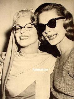 two women in black and white posing for the camera