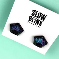 Elevate your accessory game with these captivating gothic stud earrings. Meticulously handcrafted, these earrings exude an alternative and witchy vibe that's sure to turn heads. Crafted from black resin, they boast an iridescent matte finish that adds an enchanting touch. As light dances across their surface, a mesmerizing color shift unfolds, transitioning gracefully from deep, mystical purple to ethereal shades of blue. These earrings perfectly capture the essence of dark elegance and are a te Alternative Earrings, Witchy Earrings, Neutral Jewelry, Iridescent Black, Dark Elegance, Lightning Bolt Earrings, Glitter Earrings, Black Resin, Rainbow Earrings