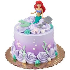 the little mermaid cake is decorated with purple icing