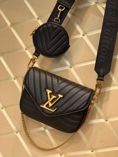 Louis Vuitton introduces the versatile New Wave Multi-Pochette crossbody handbag in quilted calf leather. With its wide strap, featuring an embroidered “Louis Vuitton” signature, gold-color chain for hand or short shoulder carry, and round coin purse clipped on the strap’s snap hook, all removable, it is the very definition of a versatile fashion accessory. Detailed Features 19 x 14 x 5 cm (Length x height x width ) Black Smooth calf leather Calf-leather trim Microfiber lining Vintage gold-color Pochette Louis Vuitton, Louis Vuitton New, Round Purse, Black Leather Shoulder Bag, Sierra Leone, New Wave, Wide Straps, Bottega Veneta, Cross Body Handbags