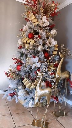 a christmas tree decorated with gold, silver and red ornaments