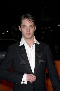 a man in a tuxedo posing for the camera