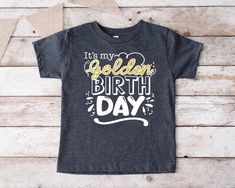 "It's My Golden Birthday Shirt,Golden Birthday Girl Tee,Birthday Party Gifts,Golden Birthday Boy Tshirt,Gold Toddler Birthday Tee,I'm Golden WE DON'T USE A REAL GLITTER. 🎁 Enjoy your shopping ! Need custom made shirts? Don't hesitate to message us! Thanks for your support! CustomShirtsZone_ Family ✨There are all sizes in the dropdown menu. These designs are for both kids and adults. Please make sure you purchased the correct size. ----- How To Order ----- 1-) Please, check and review all the photos. 2-) Choose your t-shirt size and color. *Different styles of shirts may have different shades of same color choice due to different manufacturer brands. *For this reason, we recommend you to match shirts from the same styles if you want precisely matching colors (ex. Unisex, V-necks, Toddler, Gold Top With Graphic Print For Birthday, Gold Graphic Print Top For Birthday, Gold Top With Graphic Print, Gold Letter Print T-shirt For Birthday, Gold T-shirt With Letter Print For Birthday, Golden Birthday Shirt, Birthday Party Gifts, Golden Birthday, Custom Made Shirts