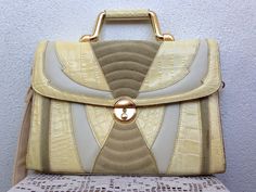 "This is an off white ladies satchel which dates back to the 80s. It is made of genuine leather with a few different textures - suede, lizard and crock embossed. The geometric pattern catches the eye and makes this classic ladies briefcase stand out. There is a gold tone closure. The sturdy metal handle looks polished and glamorous. With this amazing satchel you can be chic at work, in the office, at school or in the mall. This Italian leather cross body bag is very sturdy and well made. It is s Ladies Briefcase, Beige Satchel, Geometric Purse, Structured Handbags, Beige Purses, Briefcase Women, White Shoulder Bag, Top Handle Bags, Leather Briefcase