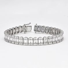 A chic row of channel set baguette diamonds flanked by classic round brilliant diamonds in a dome shaped setting, the bracelet embodies simple elegance at any occasion. Make sparkle a priority with this glamorous diamond tennis bracelet. Artfully set in 18k white gold, this exquisite bracelet features the soft shimmer of diamond baguette links gorgeously enhanced by round-shape diamond dome borders Diamond Bracelet Metal: 18kt White Gold Weight:19.43 Grams Gemstone: Natural Diamonds Shape: Bague Gold Tennis Bracelet, Diamond Earrings Studs Round, Diamond Baguette, Bracelet Diamond, Authenticity Certificate, Diamond Tennis Bracelet, Colorless Diamond, Baguette Diamonds, Wedding Jewelry Bracelets