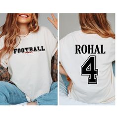 Custom Football Mom Shirt, Personalized Football Mom Shirt Gift, Name and Number Player  Football Shirt, Game Day Football Tee, Sports Mom, Football Dad Shirts 👉HOW TO ORDER👈 1️⃣ Please review all the information provided before placing an order 2️⃣ Select the shirt type and size using the drop down menu. 3️⃣ Select the color of the shirt using the following drop down menu. 4️⃣ Need more Items? Add the current item in the cart. And If you like to add more items to your order please press the back button and repeat steps 1-3 again. 5️⃣ Once all your desired items are in your cart you may complete your order by entering your payment method, desired shipping address and click submit. 👉SIZING👈 If you are unsure about the size you should order, please refer to the size chart in the pictures School Spirit Crew Neck Shirt For Sports Season, Football Season Team Spirit Tops With Lettering, Game Day Shirt With Letter Print For Sports Season, Football Season Crew Neck Top With Lettering, Game Day Letter Print Shirt For Sports Season, School Spirit Short Sleeve Shirt For Sports Season, White Sports Fan Shirt With Letter Print, White School Spirit Shirt With Name Print, White School Spirit Shirt With Letter Print