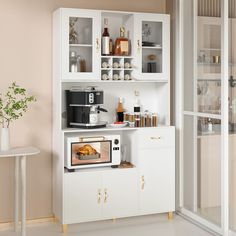 a microwave oven sitting on top of a white cabinet