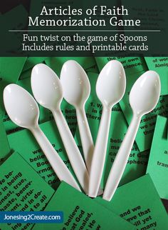 a pile of white spoons sitting on top of green cards