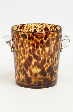 an animal print glass cup with two handles