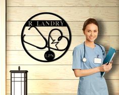 a woman in scrubs is holding a clipboard and standing next to a sign that says r l n d y