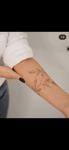 a woman's arm with a flower tattoo on the left side of her arm