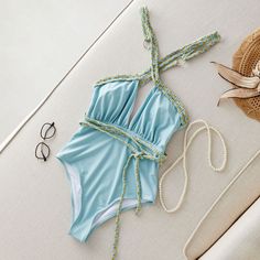 Unleash your inner beach goddess with our captivating one-piece swimsuit. The daring deep V-neckline exudes confidence, while the crisscross back adds a touch of intrigue. Removable pads ensure a personalized fit, and the tranquil light blue hue—reminiscent of a refreshing aqua mist—mirrors the serene ocean. Crafted sustainably, this swimsuit features a woven rope tie detail, making it your eco-friendly companion for sun-soaked adventures. Shop now at Rita Rosa Brazilian Beachwear! 🌊👙🌴🌟Impor Beach Goddess, Swimsuit Sale, Crochet Crop Top, Crochet Headband, Nylon Fabric, Cross Straps, Blue Hues, Deep V, One Piece Swimsuit