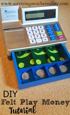 a toy cash register sitting on top of a table with money in it and the words diy felt play money