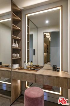 a dressing table with a stool and mirror