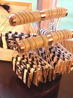 a table topped with lots of gold and black bracelets on top of each other