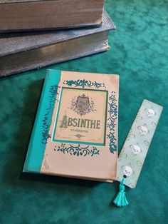 an old book sitting on top of a green carpet