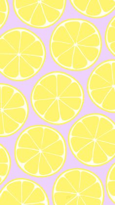 a group of lemons cut in half on a pink background