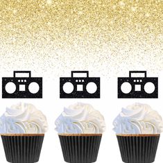 three cupcakes with white frosting in front of a gold glitter background and boombox