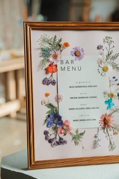 a framed menu with colorful flowers on it