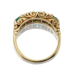 Antique Zambian Emerald and Diamond Half Hoop Ring The Archie ring is an authentic vintage emerald and diamond ring from the Edwardian Era circa 1910. This GIA-certified ring features three Asscher cut Zambian emeralds of moderate enhancement combining for approximately 0.75-carats. Alternating between the emeralds are two Old European Cut diamonds of approximately I-J color, VS clarity combining for roughly 0.38-carats. Eight small diamonds are set between the stones. The stones are set in an 1 Antique Emerald Ring For Collectors, Antique Round Multi-stone Emerald Ring, Victorian Yellow Gold Emerald And Diamond Ring, Antique Gold Multi-stone Emerald Ring, Vintage 1980s Emerald And Diamond Ring, Victor Barbone Jewelry, Antique Gold Rings, Emerald And Diamond Ring, Zambian Emerald