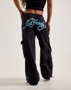 Take your Y2K outfit to the next level with the Ed Hardy Dragon Cargo Pants. These wide-fit women's pants feature printed Ed Hardy graphics, spacious cargo pockets, and elasticized cuffs. Printed graphics Elastic waist Cargo pockets Wide fit Elasticized cuffs with adjustable drawcord