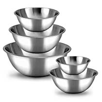 four stainless steel bowls stacked on top of each other in front of a white background