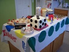 a table covered with cakes and desserts in the shape of dices on it