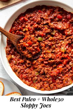 a white bowl filled with chili and bread