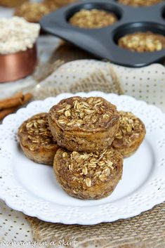 three baked oatmeal cups on a plate with cinnamon sticks in the background