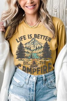 LIFE IS BETTER BY THE CAMPFIRE UNISEX SHORT SLEEVE,GRAPHIC TEE,GRAPHIC TSHIRTS,TSHIRTS,TEES100%COTTON,HEATHER(52%COTTON,48%POLY),ATH.HEATHER,BLACK HEATHER(90%COTTON,10%POLY)NICARAGUAMade In: Nicaragua Summer Camping Tops With Letter Print, Summer Camping Top With Letter Print, Summer Letter Print Tops For Outdoor Activities, Summer Letter Print Top For Outdoor, Fall Camping T-shirt With Letter Print, Letter Print Top For Camping In Fall, Casual Tops For Fall Camping, Casual Fall Tops For Camping, Graphic Print T-shirt For Fall Camping