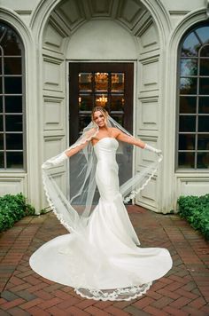 a woman in a white wedding dress and veil