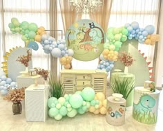 an assortment of balloons and decorations for a baby's first birthday