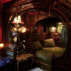 a bedroom with an ornate bed and mirror