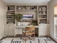 a chair sitting in front of a desk with bookshelves and shelves above it