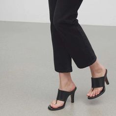 Elegant Black Mules With Wooden Heel, Elegant Square Toe Mules With Wooden Heel, Black Mules With Single Toe Strap, Elegant Mules With Stacked Heel And Single Toe Strap, Black Leather Mules With Sculpted Heel, Leather High Heel Mules With Wooden Heel, Leather Mules With Wooden Heel And Pointed Toe, Black Mules With Heel Loop And Single Toe Strap, Workwear Mules With Wooden High Heel