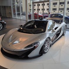 a silver and black sports car in a showroom