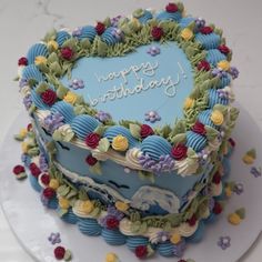 a heart shaped birthday cake on a plate