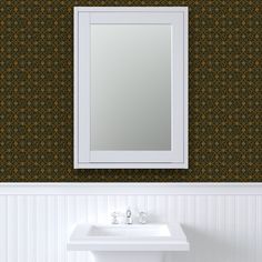 a white sink sitting under a bathroom mirror next to a wall mounted faucet