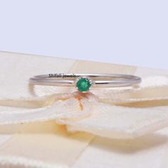 "RING DETAIL Metal : 925 sterling silver Center stone : Emerald Size of stone : 2.5mm Shape : Round About gems stone Emerald Emerald is a valuable gemstone that is likewise referred to by different names, for example, \"Panna\", \" Zamarrud\", \"Maragdam\", and \"Greenstone\" The tone changes from green to greenish-blue. It has a place with the mineral Beryl, the green is brought about by the presence of chromium, vanadium or iron (or any blend of those three components) and incorporates sea blu Dainty Emerald Stackable Rings, Dainty Stackable Gemstone Rings, Minimalist Green Jewelry With Simple Design, Green Sterling Silver Stackable Promise Rings, Sterling Silver Stackable Emerald Ring As Gift, Minimalist Emerald Stackable Promise Rings, Minimalist Sterling Silver Emerald Ring For Gift, Green Sterling Silver Stackable Emerald Ring, Sterling Silver Emerald Ring With Round Band As Gift